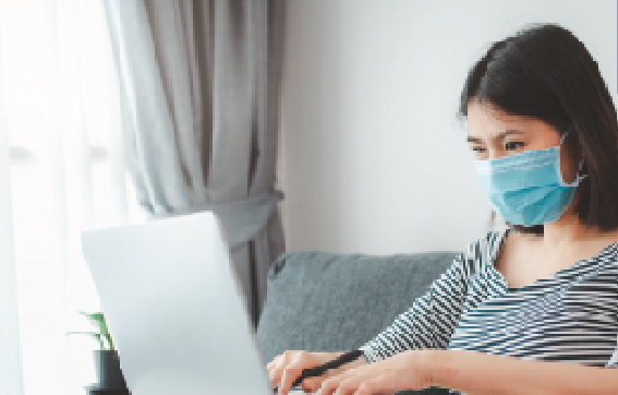 Image, woman with facemask on laptop